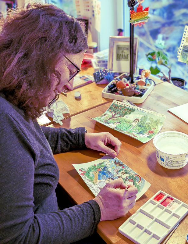 Artist Dorothy Tully paints in a colorful illustration with watercolor