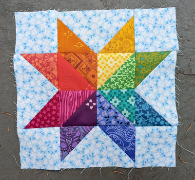 Rainbow star quilt block with spectrum colors, sewn by Dorothy Tully, artist author children's book illustrator of Dorybird Handmade, offering cotton baby & children's clothes, girls dresses, cloth diaper pants, bags, quilts, baby blankets, loveys, art prints, pdf sewing patterns
